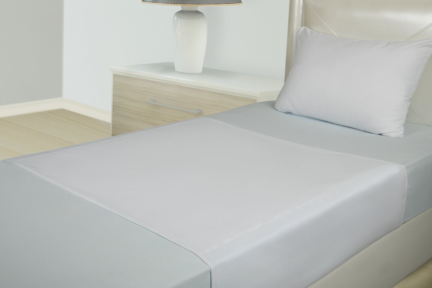 Micro 110 draw sheet laid flat on a bed with tuck-in flaps