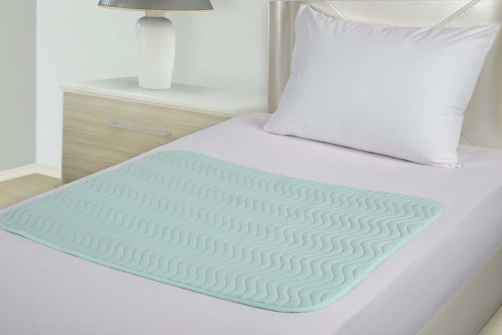 ABSO reusable underpad on a bed